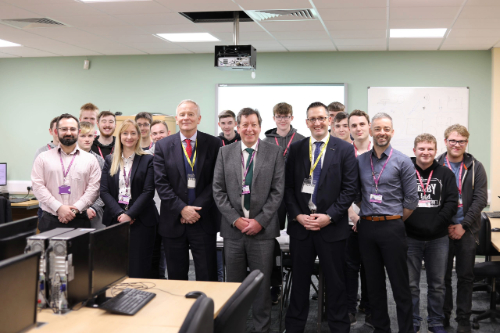 A group of adults and students stood together for a team photo.