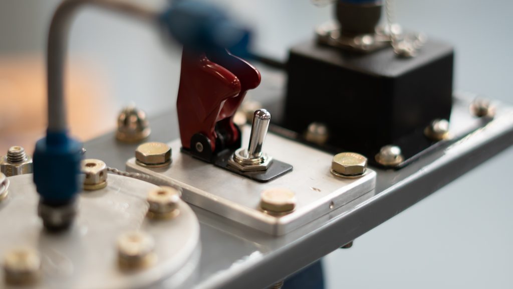 A small hardware device with nuts and bolts on