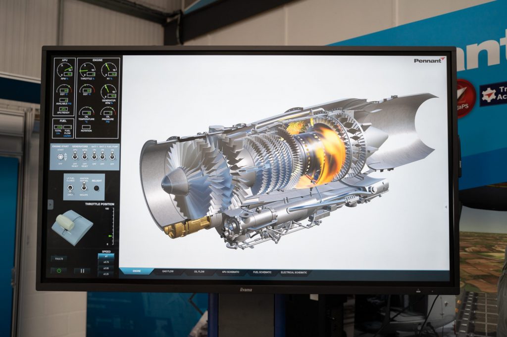 A large display screen with an aircraft engine on the screen. The engine is metal and looks like it's about to fire up