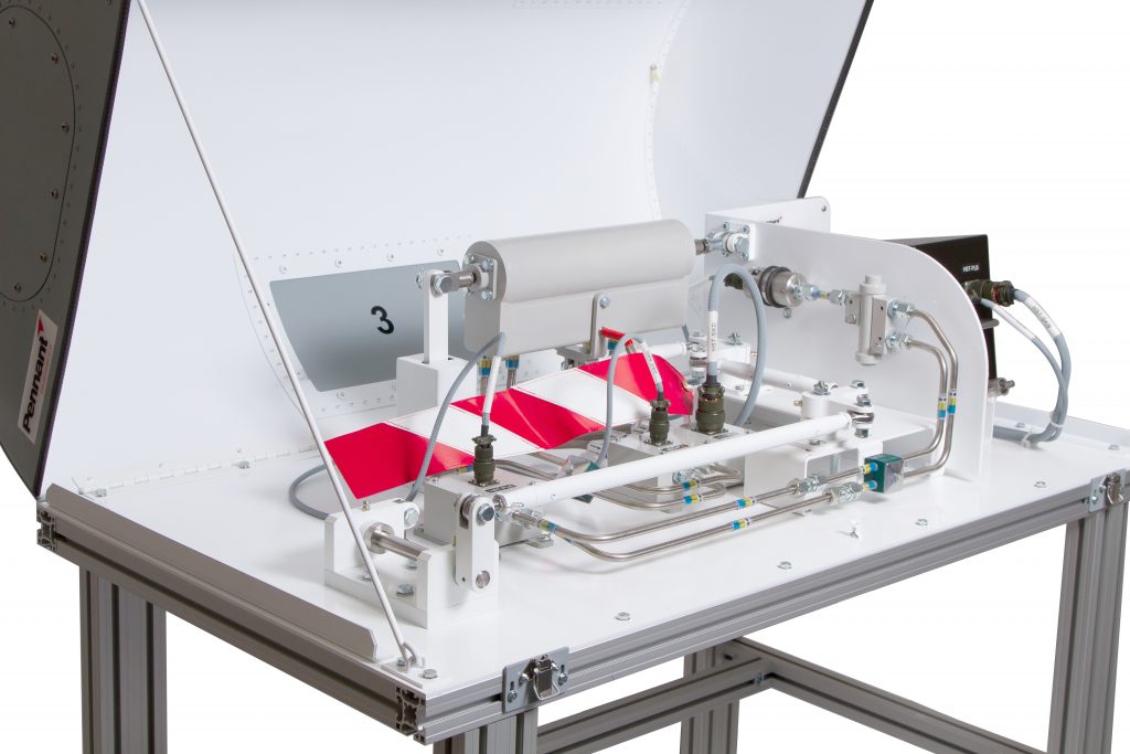 An industrial machine with a white and gray color scheme, featuring a conveyor system with red and white triangular packages. The machine is numbered ‘3’ and is mounted on a metal frame.
