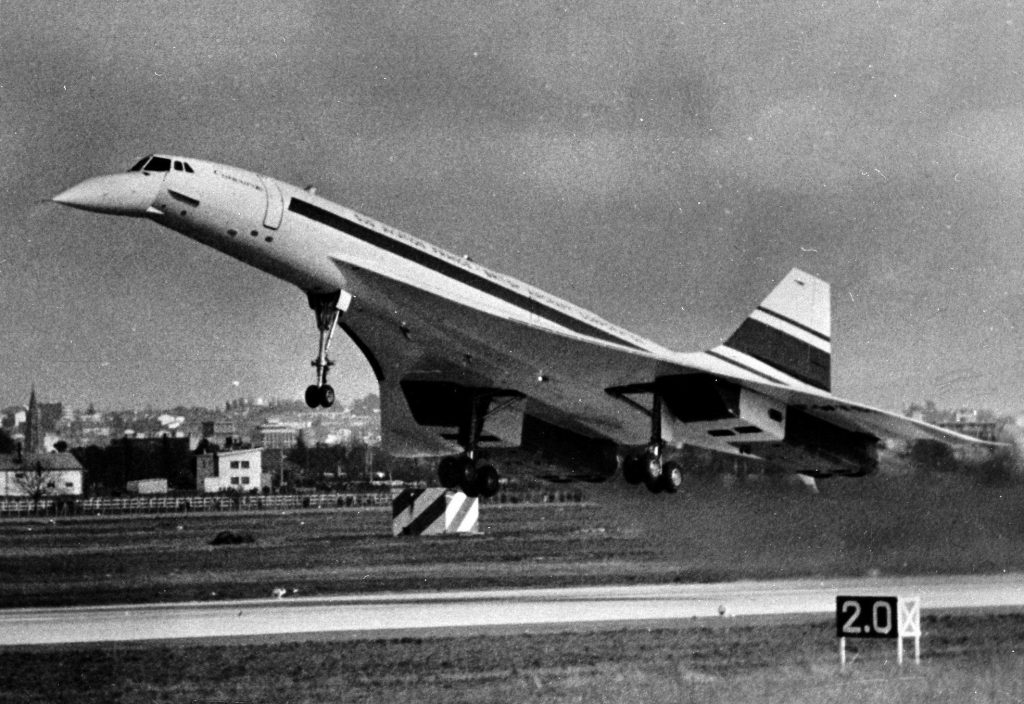 A black and white image of the Concorde taking off from the runway