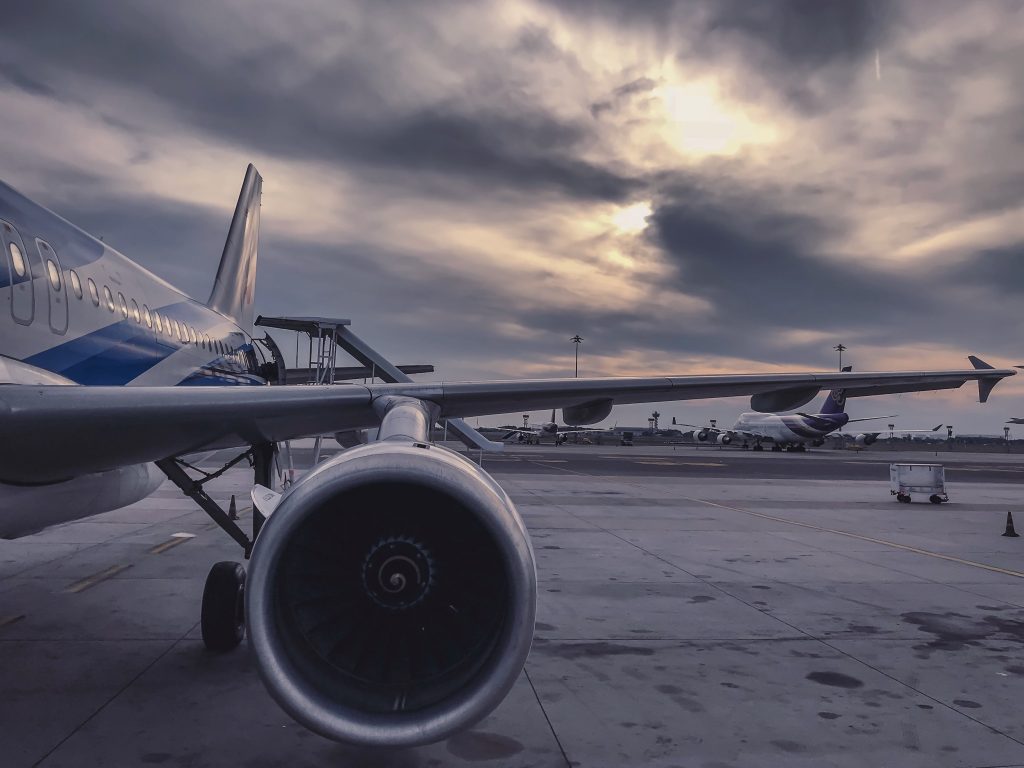 An airport runway with large aircraft in the foreground and background