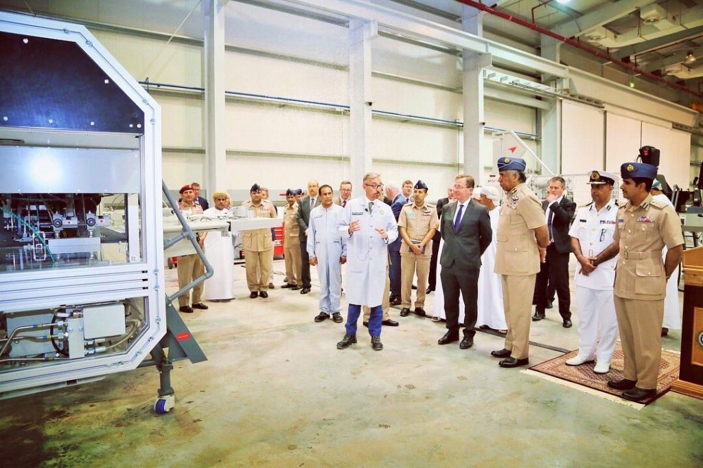A group of people stood around a piece of training equipment