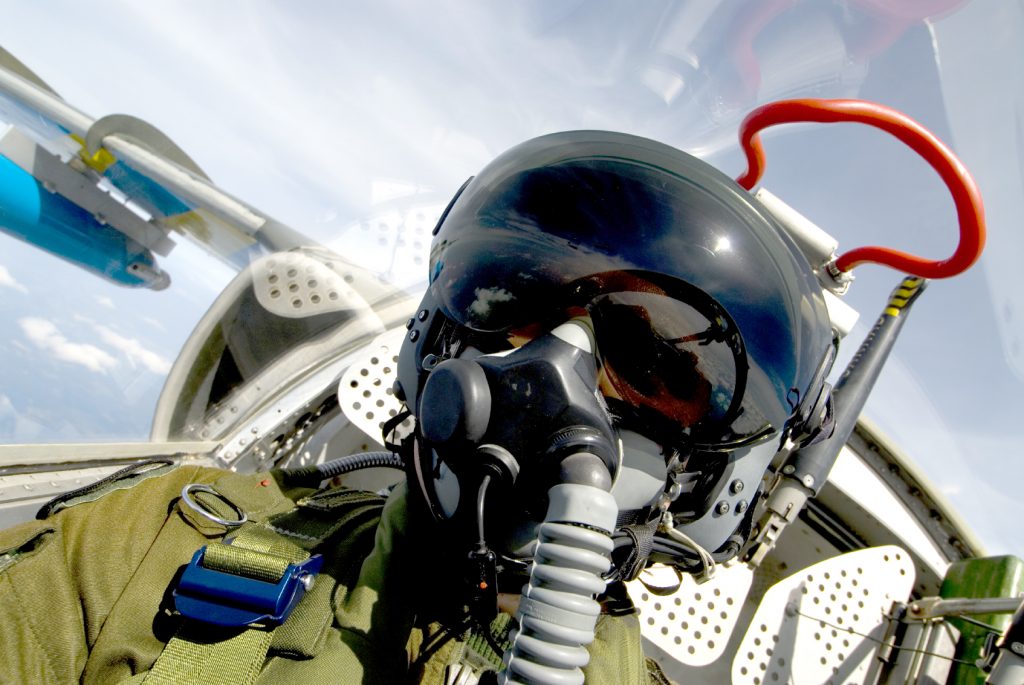 A military pilot in a plane.