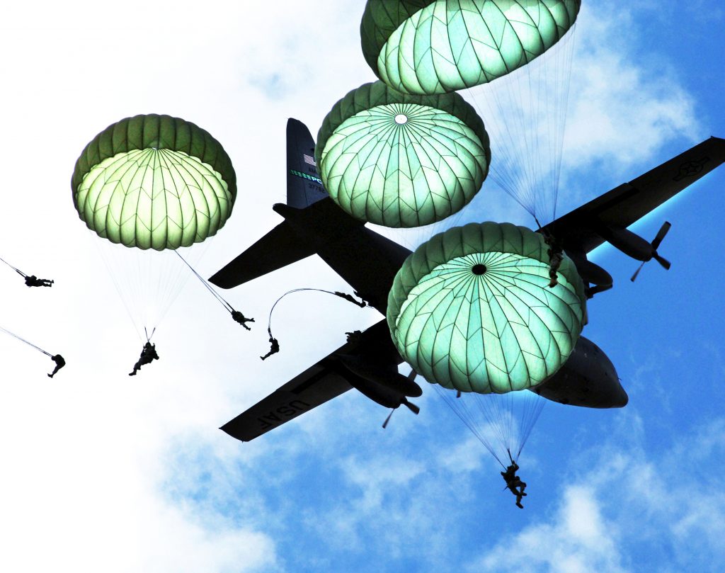 Langkawi International Maritime & Aerospace Exhibition (LIMA) 32 An image of blue sky and clouds. There are four green parachutes in the sky and an aeroplane