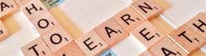 R4I WRITER PLUS STE… WHAT’S NEW! 5 Scrabble pieces laid out on a scrabble board