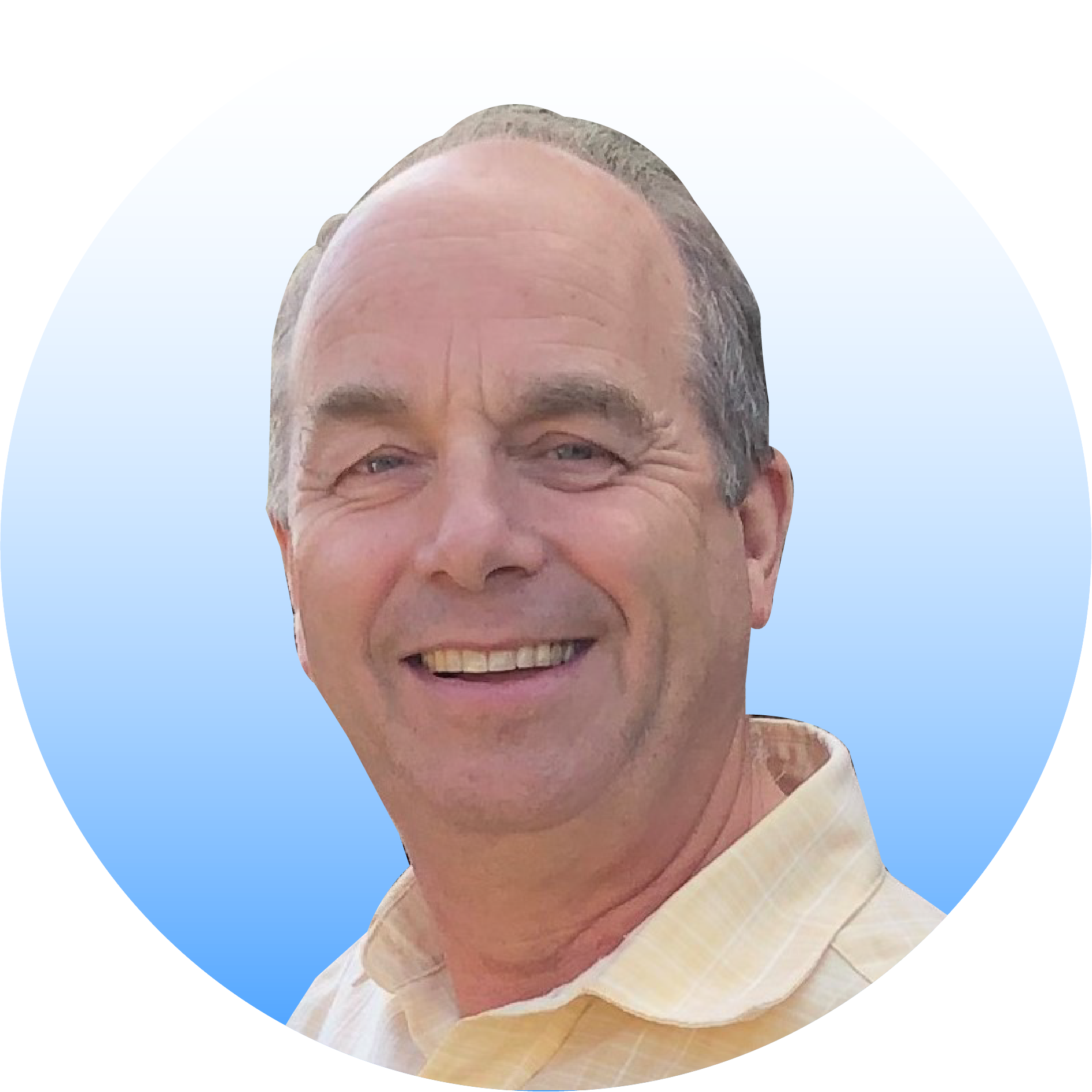 Photo of a man, Graham Brum, wearing a yellow shirt, smiling at the camera. 