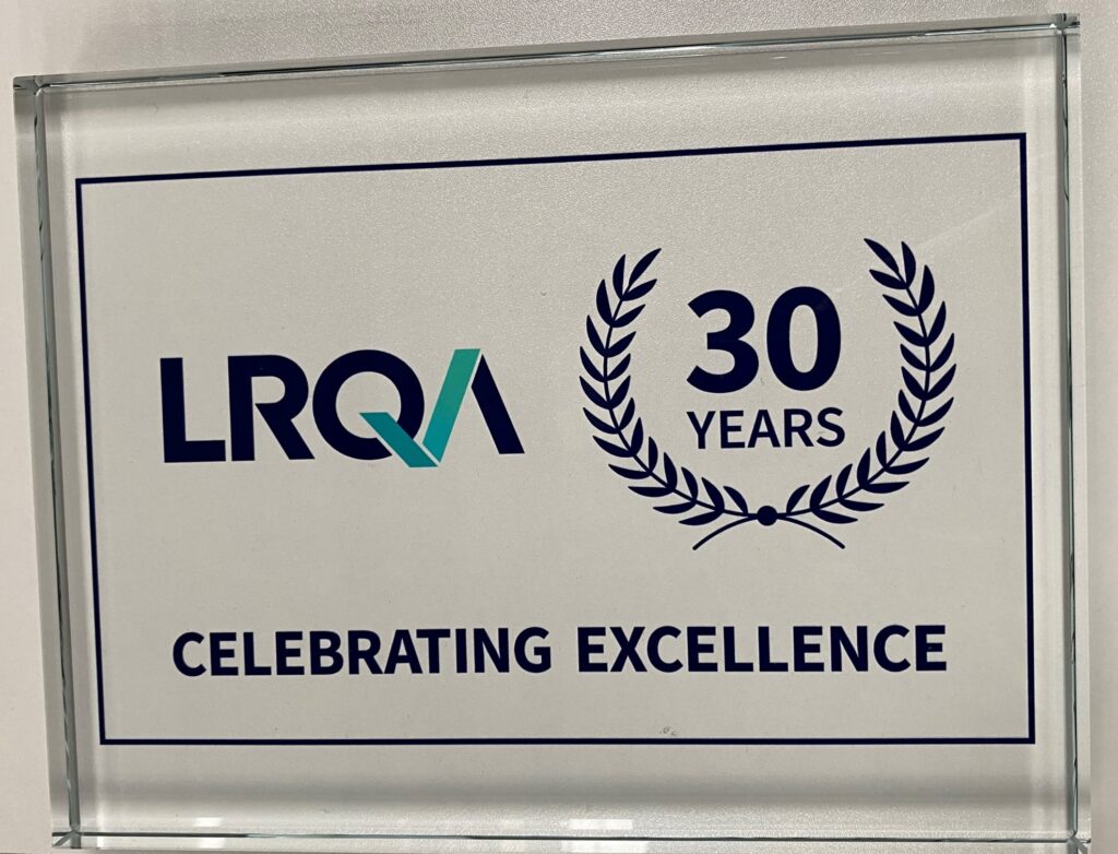 A glass plaque with the blue LRQA logo and a crest with 30 years written inside