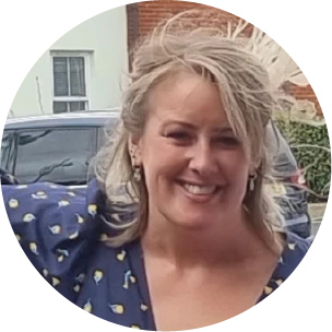  a photo of a blonde woman smiling at the camera